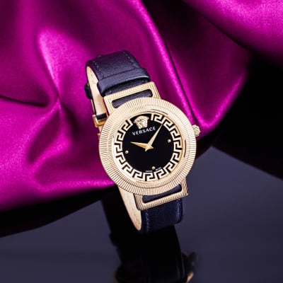 Versace watch with black dial, gold bezel and black leather band 