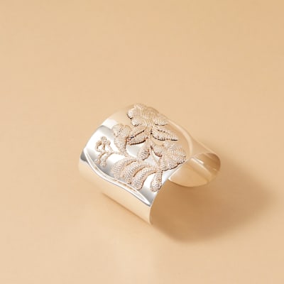 An embossed silver cuff bracelet