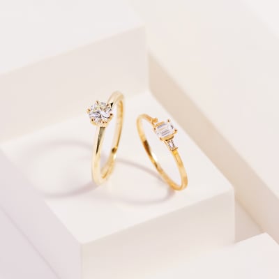A pair of small diamond rings with gold bands 