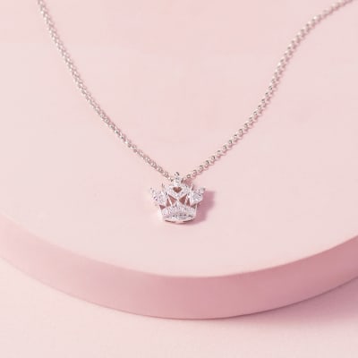 A silver and diamond crown pendant necklace 