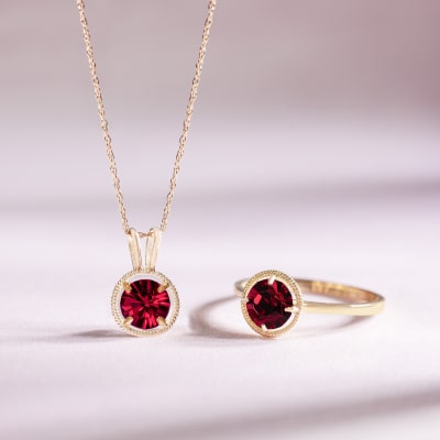a red gemstone necklace and ring 