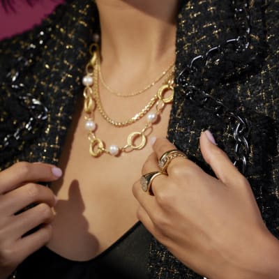 stacked gold and pearl necklaces 