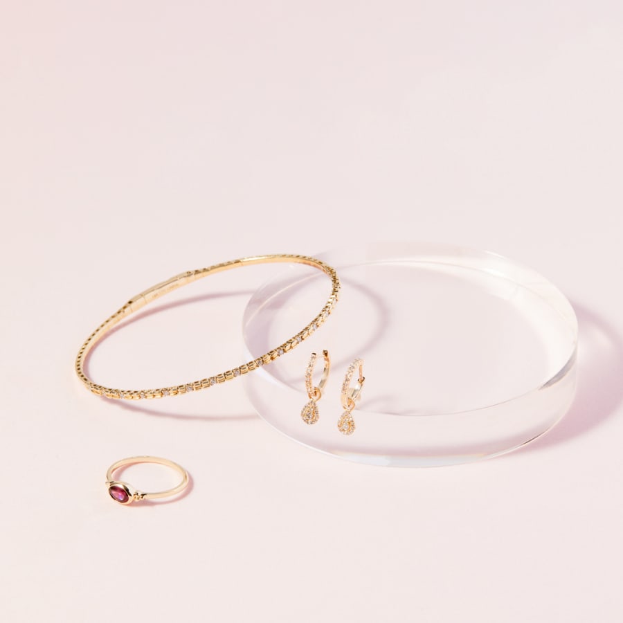 Oval garnet ring with gold bracelet and earrings 