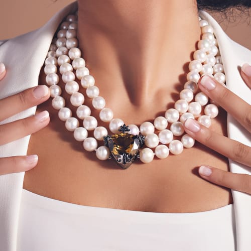 woman wearing multi-strand pearl necklace with cognac quartz center