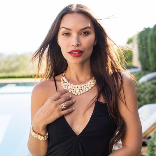 model wearing large statement jewelry pieces