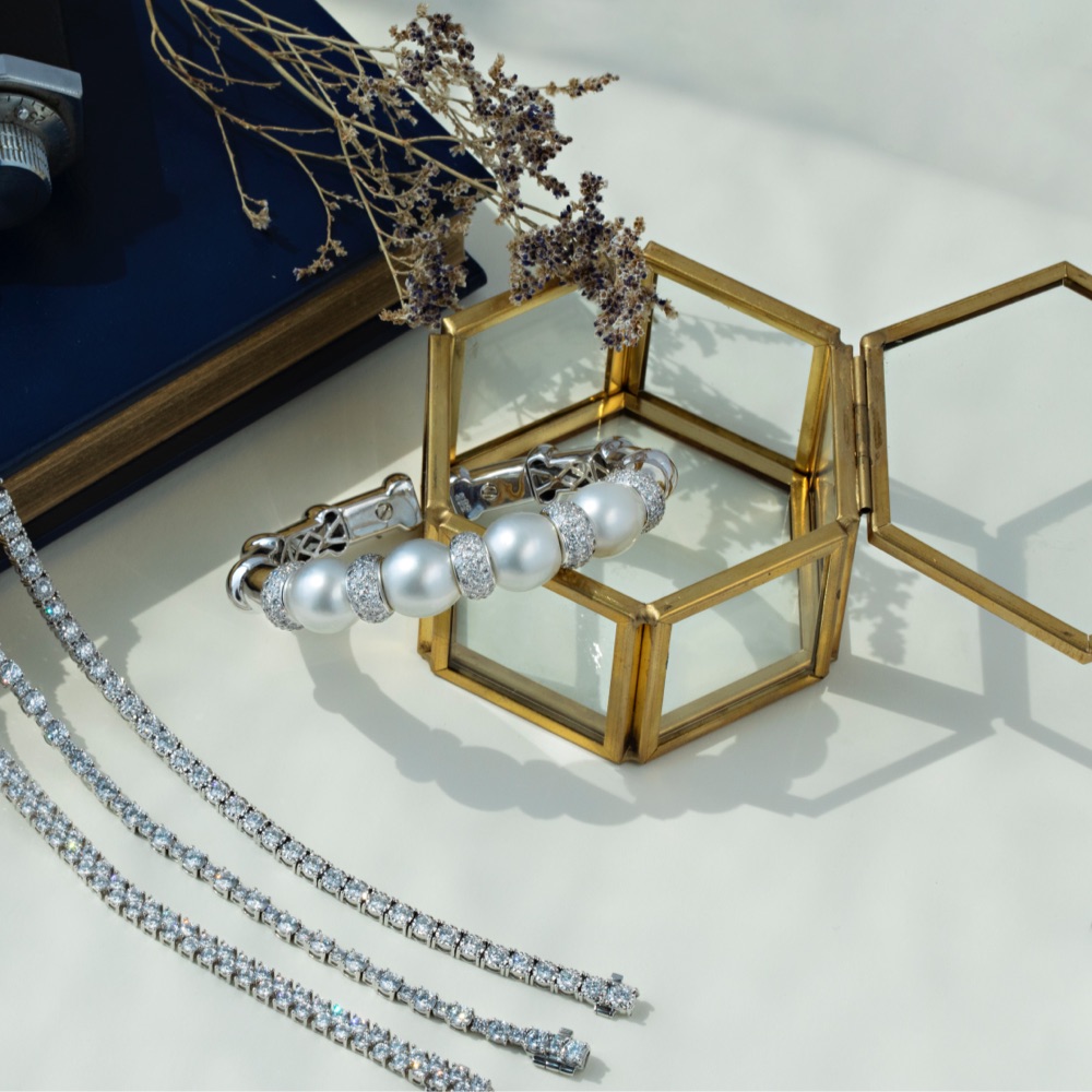 diamond tennis bracelets and large pearl bangle bracelet 