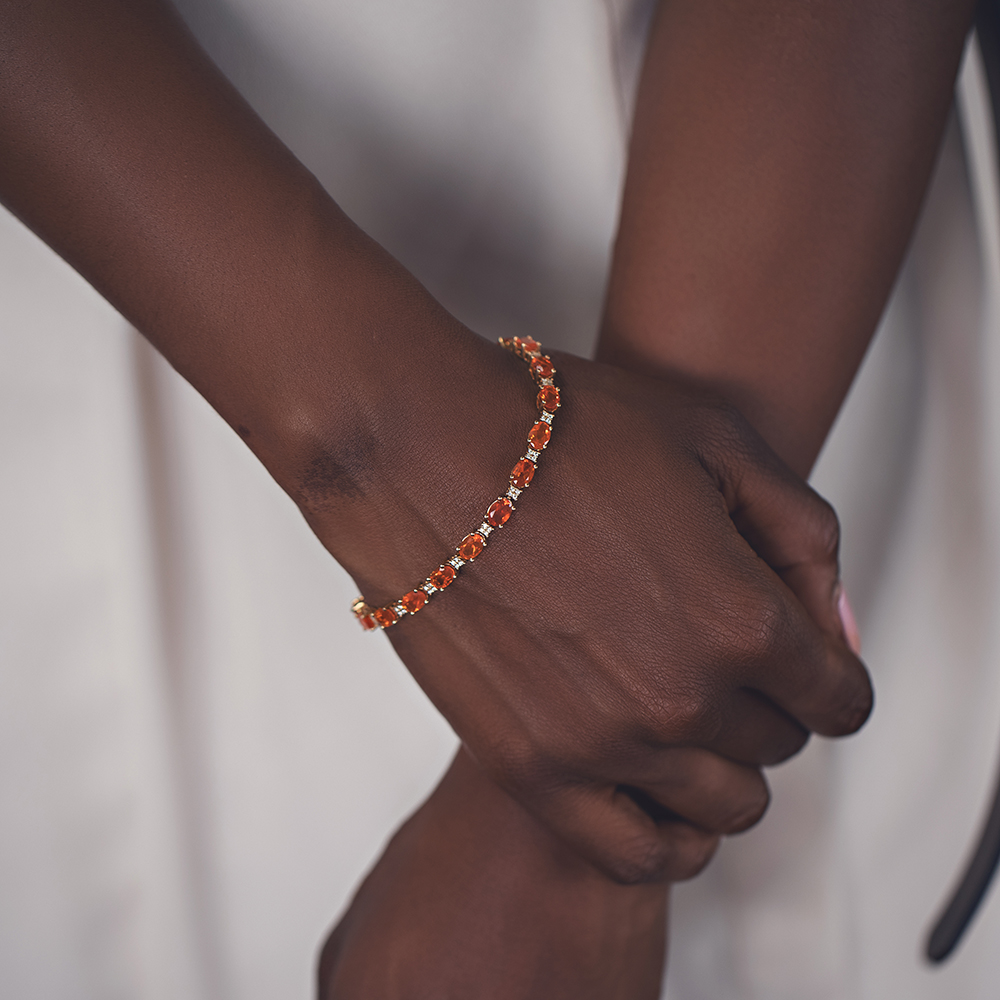 woman wearing orange gemstone tennis bracelet 