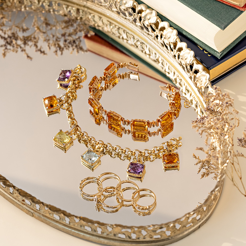 Citrine bracelet, multicolor charm bracelet, and diamond and gold rings 