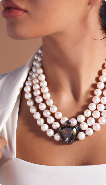woman wearing 3 stand necklace with gemstone 
