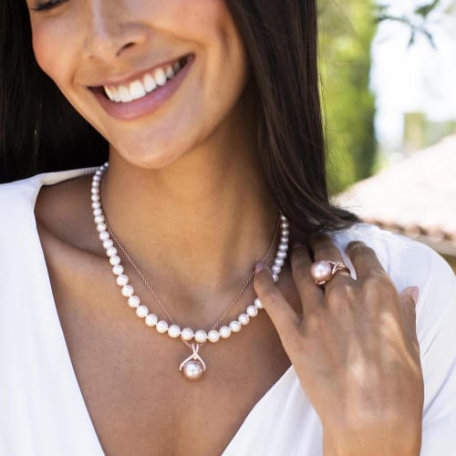 Woman wearing pearl necklaces and ring